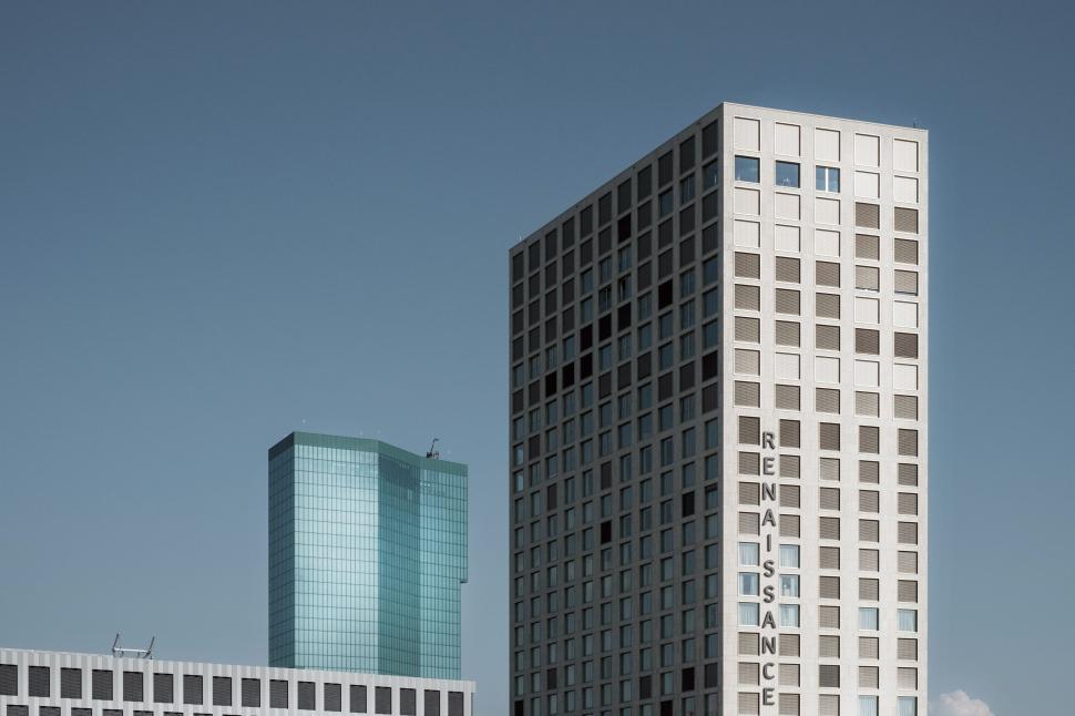 Free Image of Two Tall White Buildings Adjacent to Each Other 