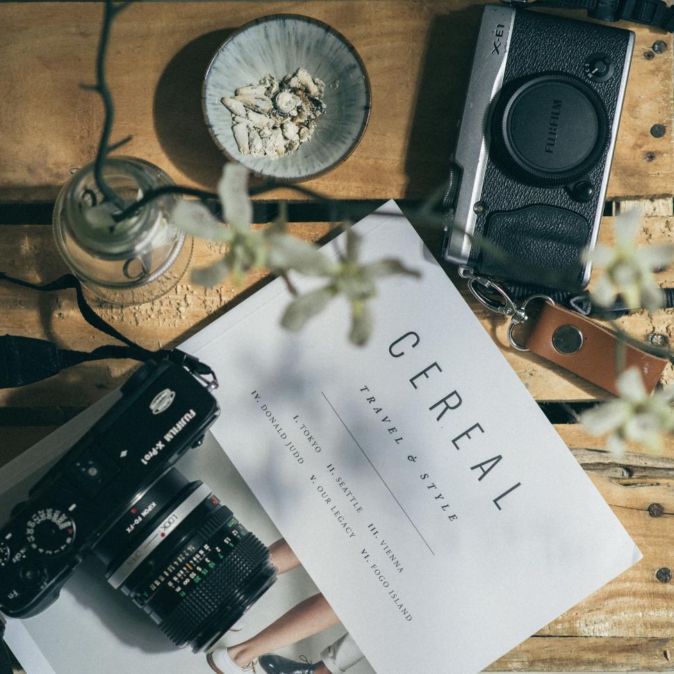 Free Image of Camera on Table Next to Book 