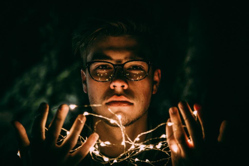 Free Image of Man Holding String of Lights 