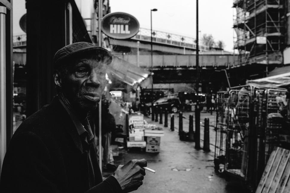 Free Image of Man Smoking Cigarette on City Street 