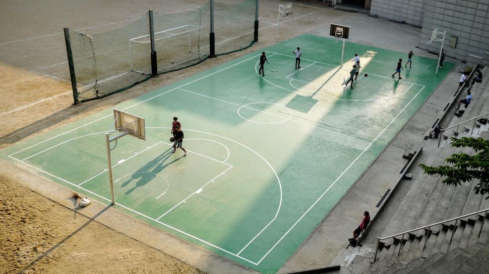Free Image of Group of People Playing a Game of Basketball 