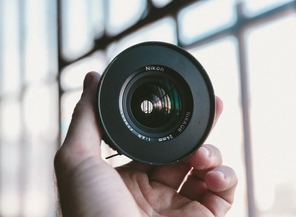 Free Image of Person Holding Camera Lens 