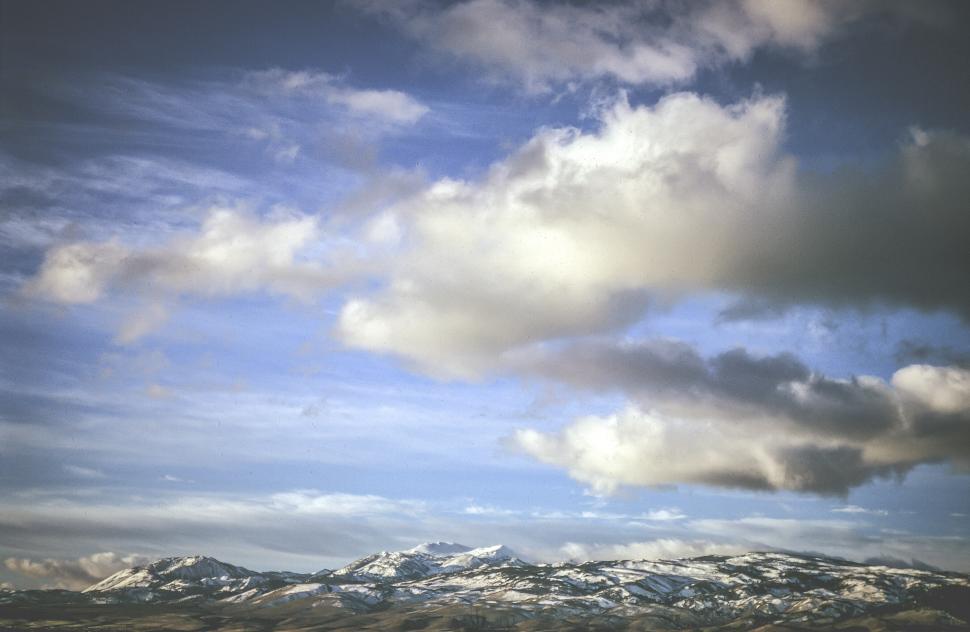 Free Image of Clouds and snow capped peaks 