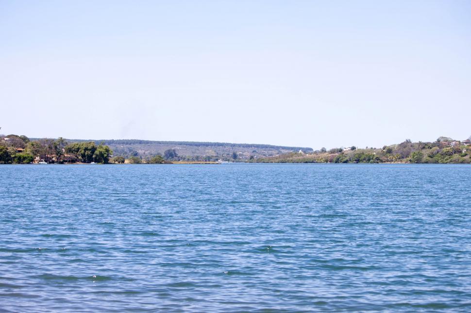 Free Image of Large Body of Water With Trees in the Background 