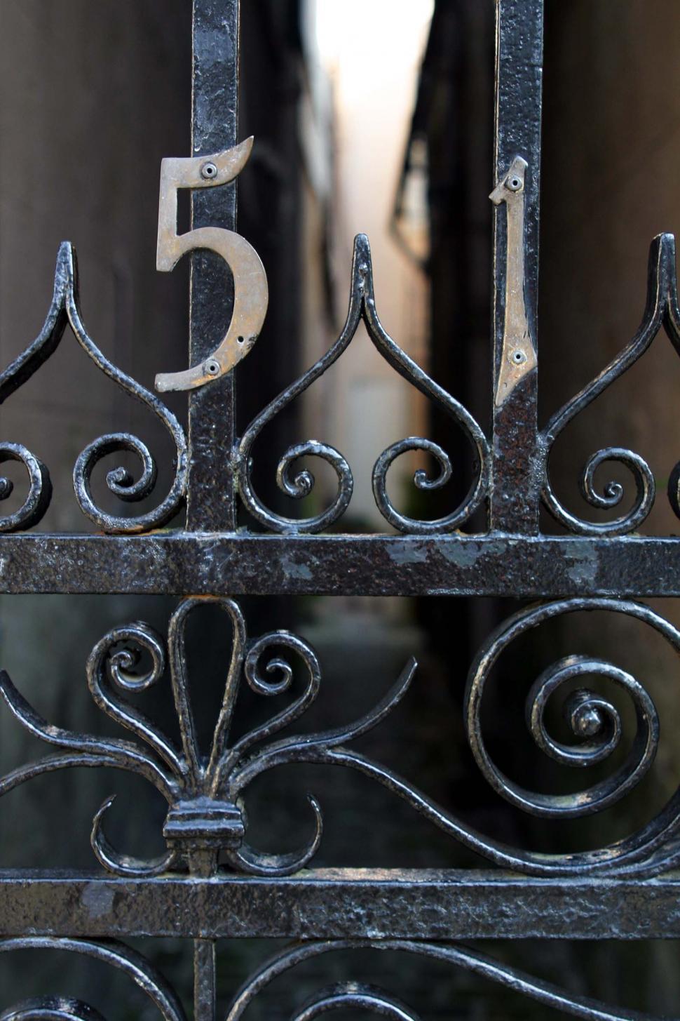 Free Image of Close Up of Metal Gate With Number Five 