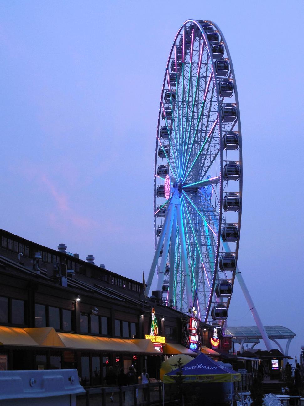Free Image of Ferris Wheel Next to Building 