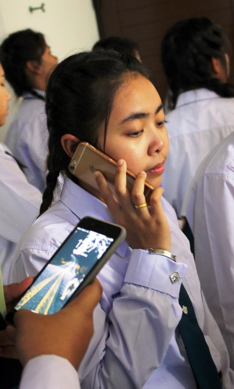 Free Image of Teenage school girl talks on a cellphone  