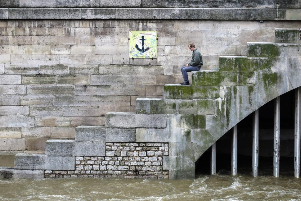 Free Image of Man sitting by the Seine 