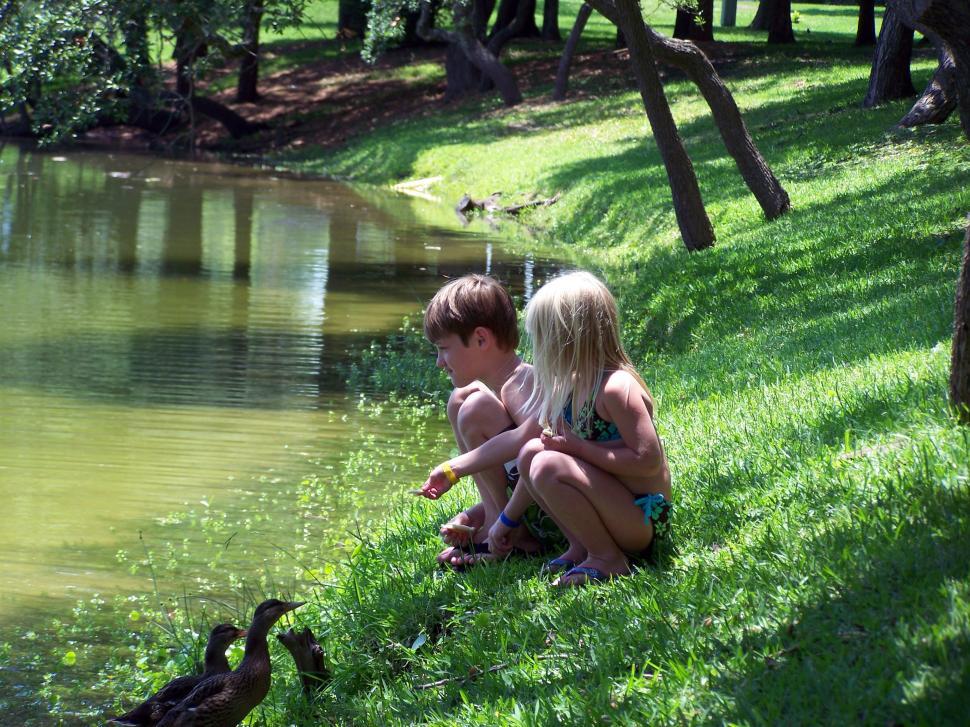 Free Image of Kids Sitting by Water 