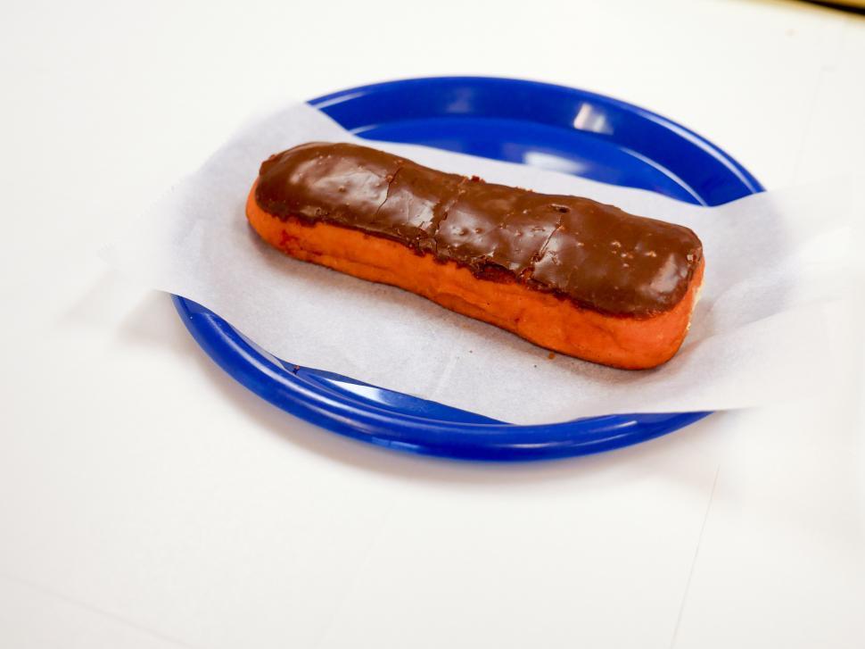 Free Image of Eclair sitting on a blue plate 
