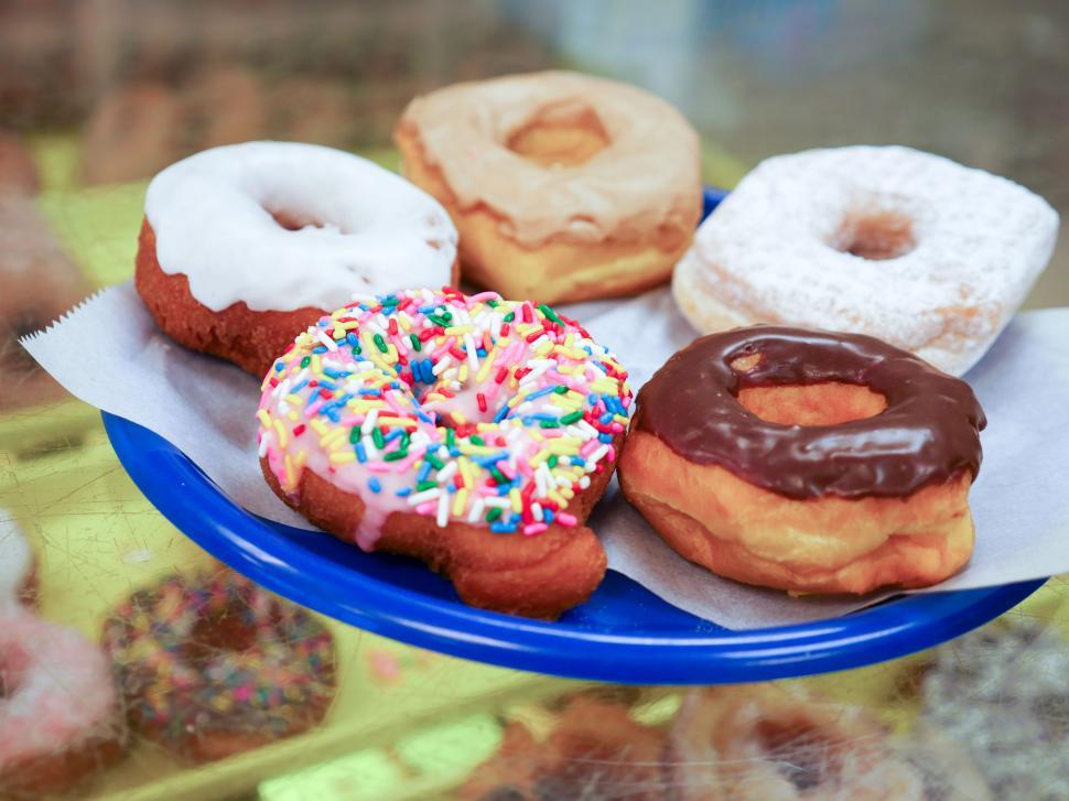 Free Image of Colorful donuts sitting on a plate 