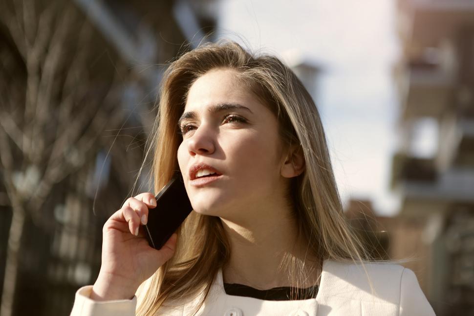 Free Image of Young Blonde Woman Talking On Mobile Phone 