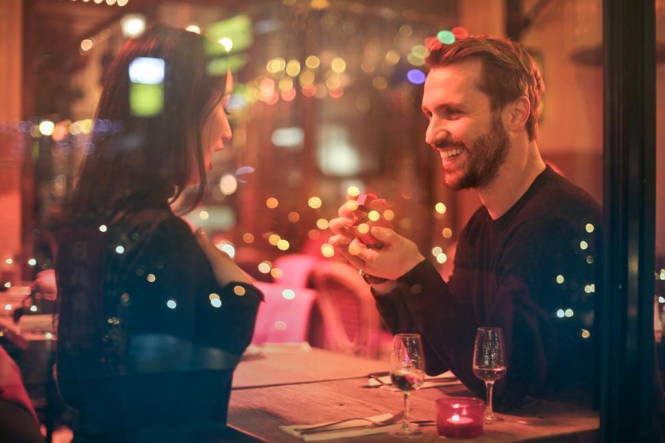 Free Image of Young Man proposing to his girlfriend in a bar 