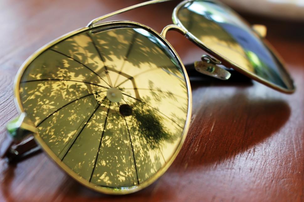 Free Image of Summer Sun Umbrella Reflection in Sunglasses  