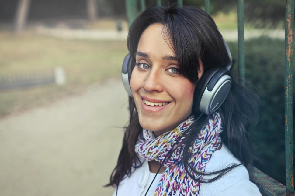 Free Image of Young Woman with headphones listen to the music in the park 