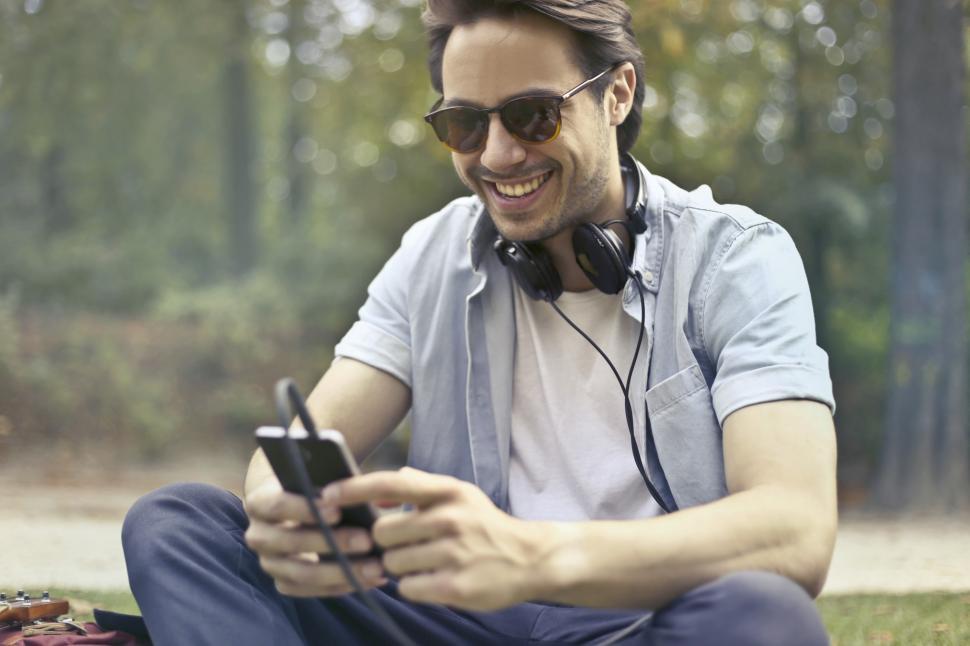 Free Image of Young Man Laughing While Listening To Music With His Smartphone 