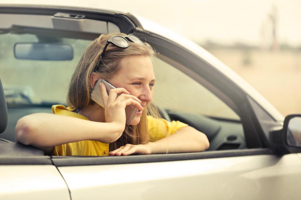 Free Image of Young Woman Wearing Half-Sleeved Yellow Shirt Talking On Phone 