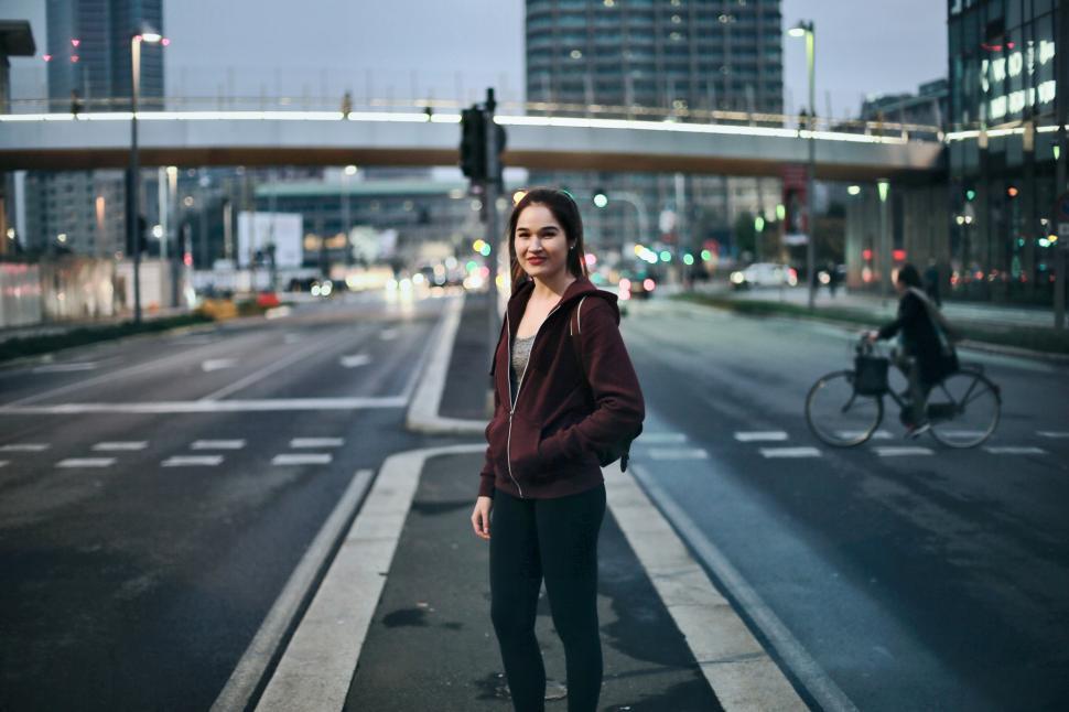 Free Image of Young Woman Posing On The Road After Coming Out From Gym 