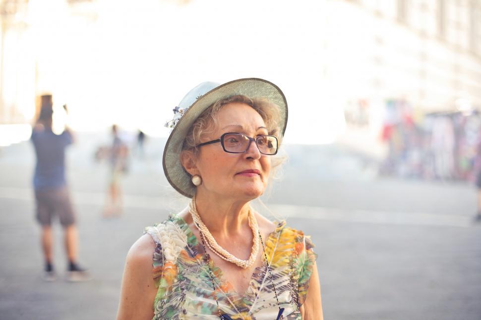 Free Image of Close-up Of Woman In Pastel Color Top And Sunhat 