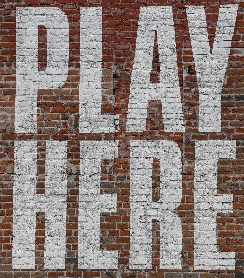 Free Image of Massive Play Here sign 