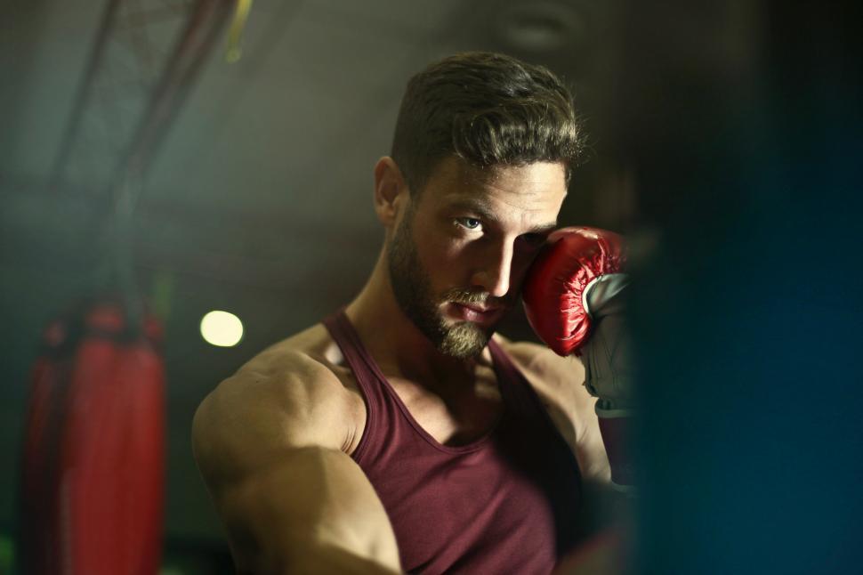Free Image of A young caucasian man man wearing boxing gloves 