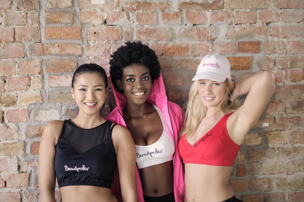 Free Image of Three multi ethnic women in sport bra posing in the gym 