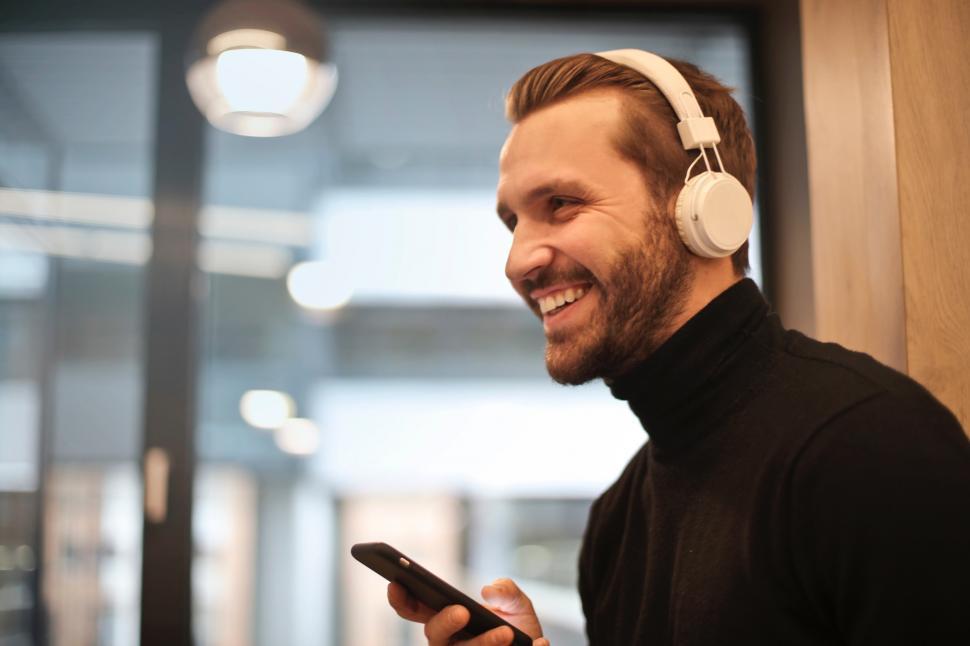 Free Image of A young caucasian man listening to music on headphones 