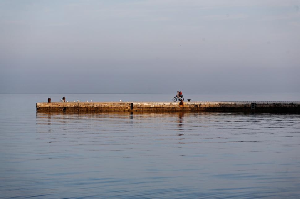 Free Image of The pier with cyclist 
