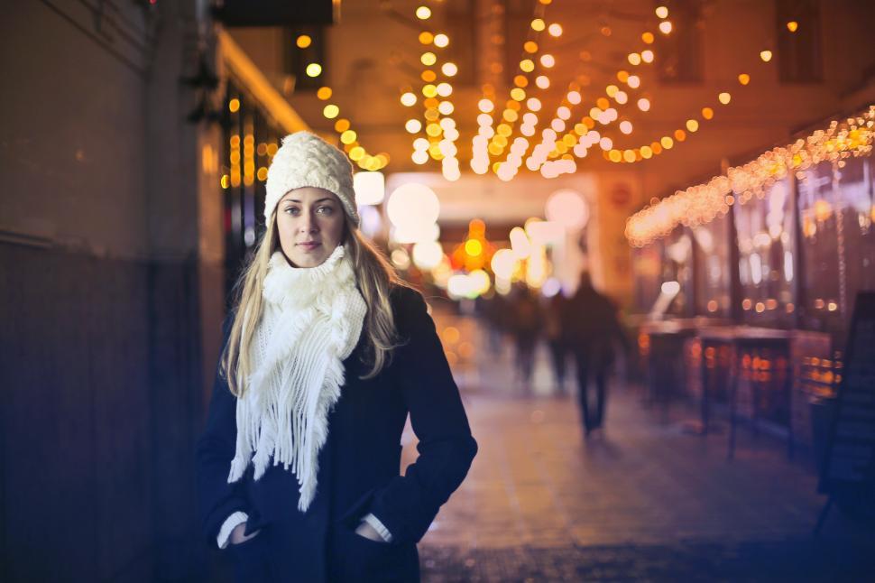 Free Image of Young Blonde Woman In Black Jacket, White Scarf And White Beanie 