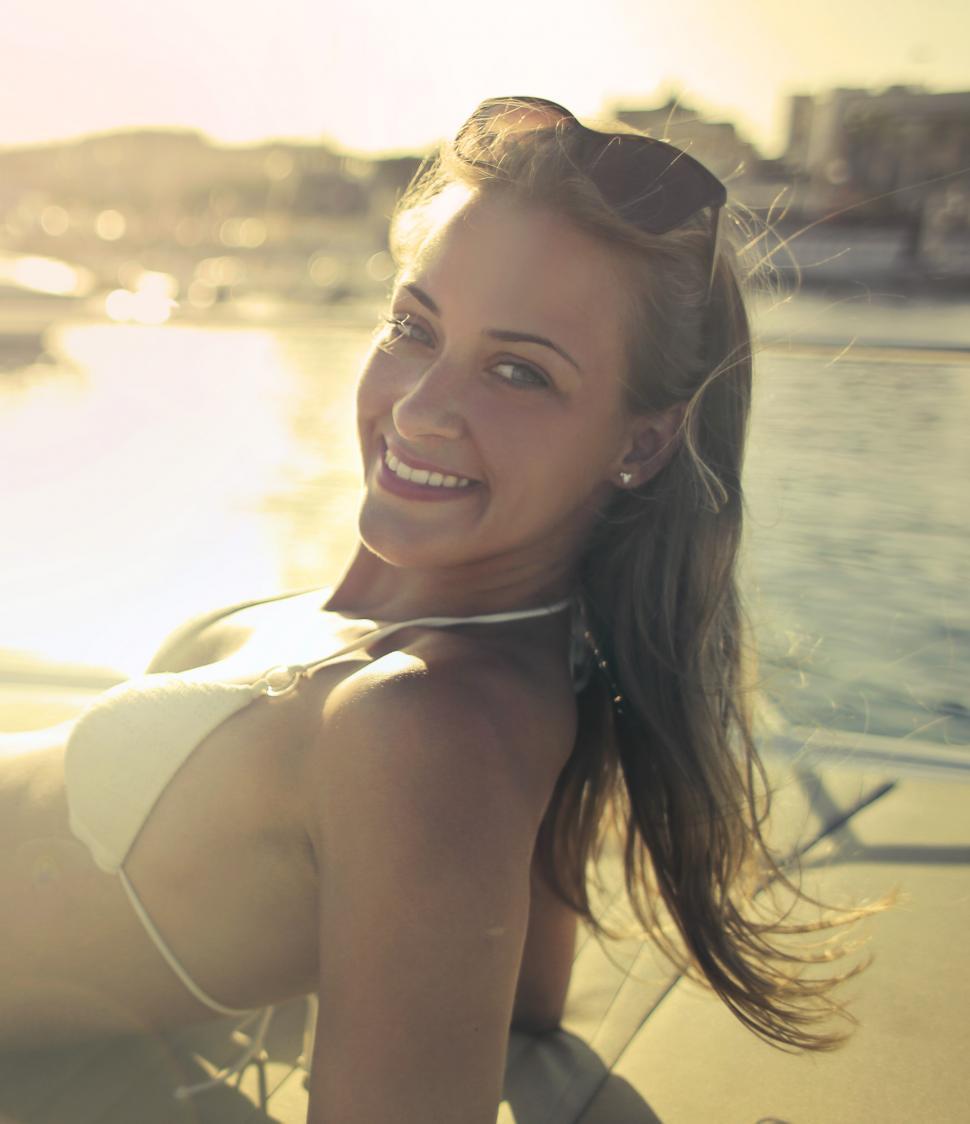 Free Image of Young Woman In White Bikini With Sunglasses On Head, Posing for 