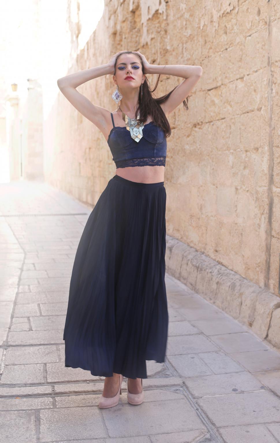 Free Image of Young Female Fashion Model Posing In Black Long Skirt With Vinta 