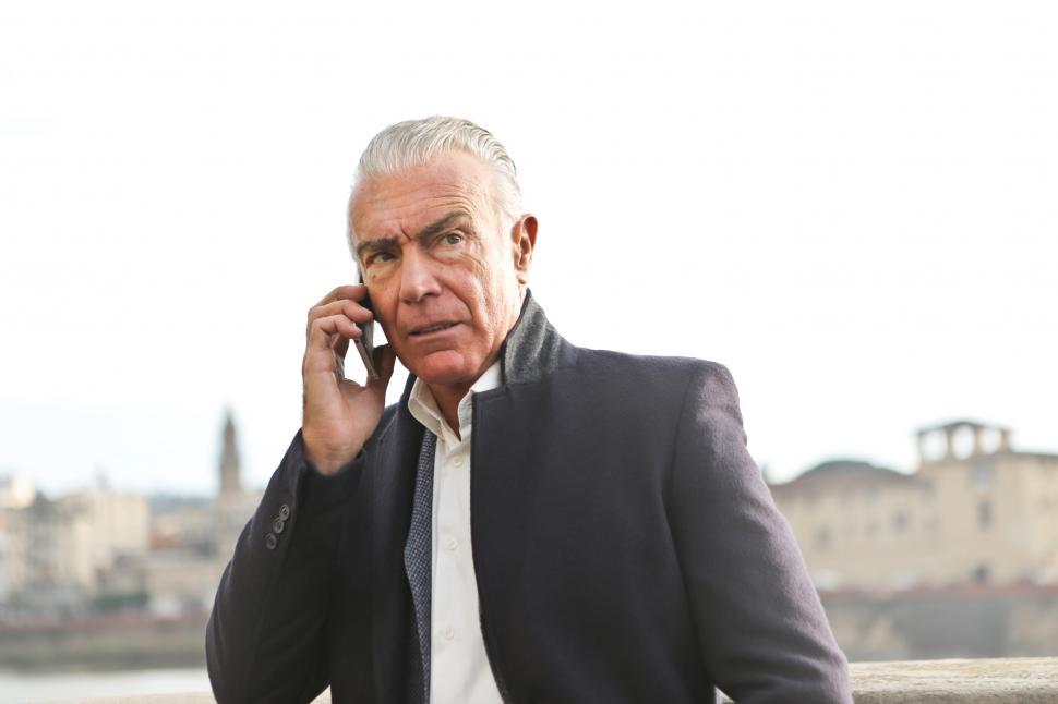 Free Image of An old caucasian man calling on his mobile phone during the day 