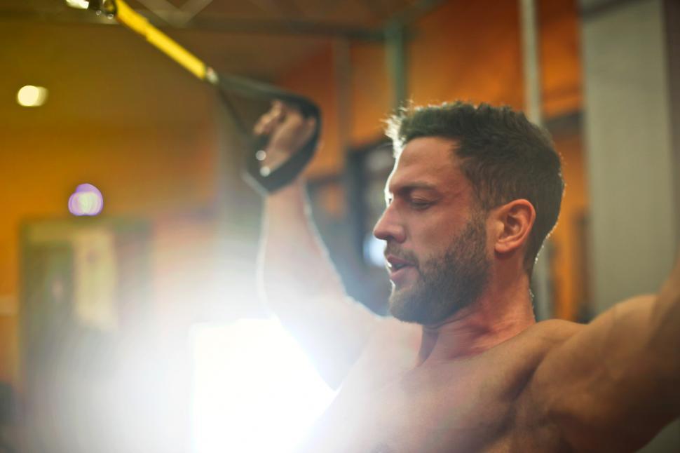 Free Image of A young caucasian bearded man exercising in the gym 