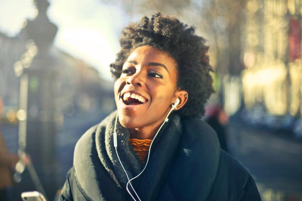 Free Image of A young african woman listening to music with earphones 