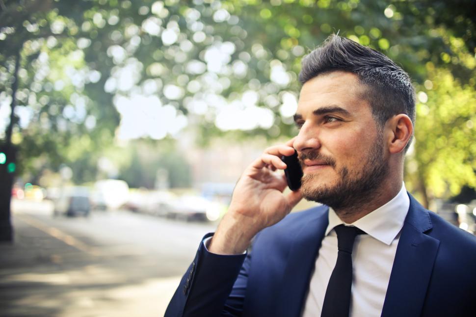 Free Image of A bearded caucasian man in formals calling on his mobile phone 