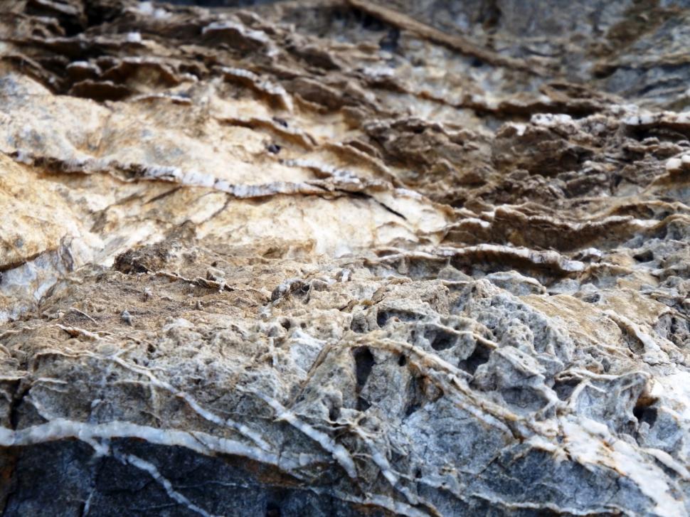 Free Image of Rough rock teture of contrasting light and dark brown color  