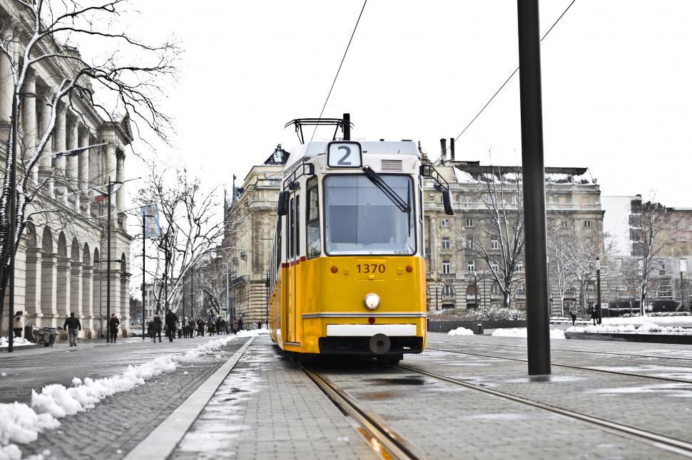 Free Image of A yellow tram on a snowy road 