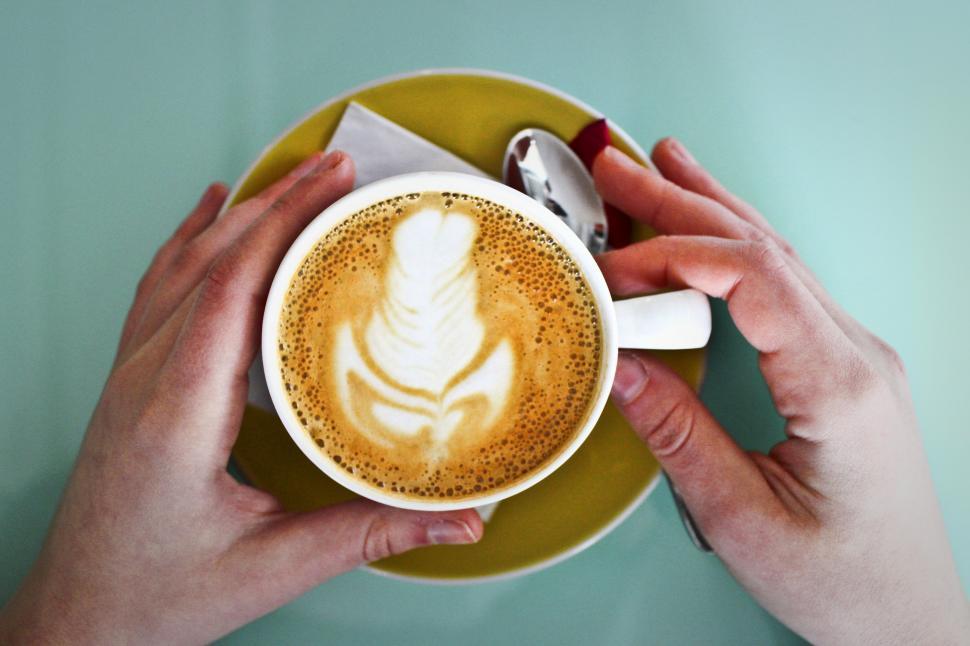 Free Image of A coffee cup held by hands 