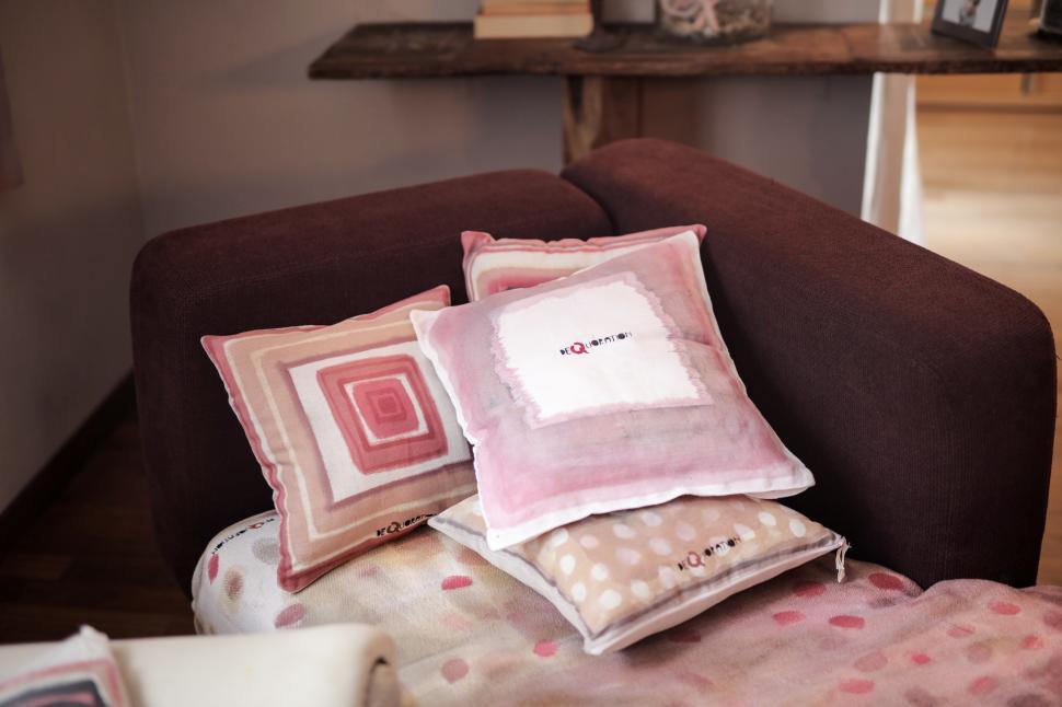 Free Image of Assorted cushions placed on a brown couch 