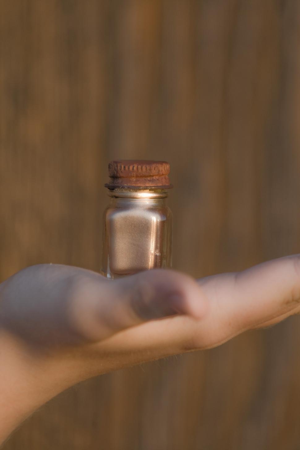 Free Image of Person Holding Small Jar in Hand 