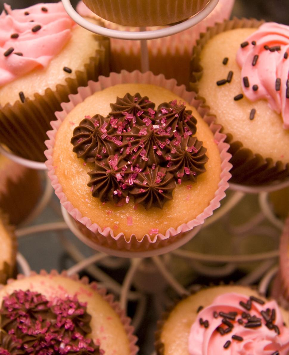 Free Image of Tray of Cupcakes With Pink Frosting and Sprinkles 