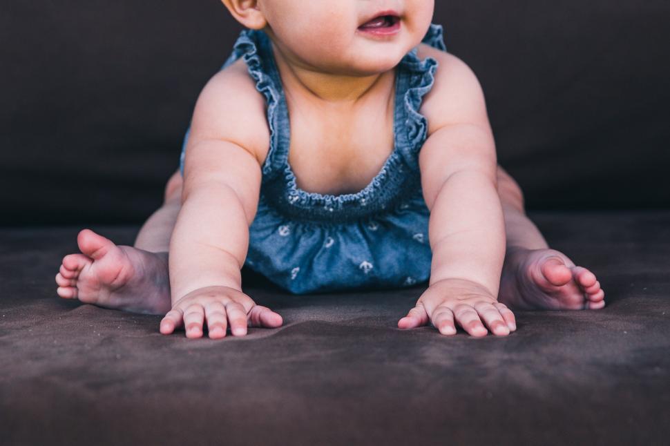 Download Free Stock Photo of A caucasian baby girl sitting in crawl position 