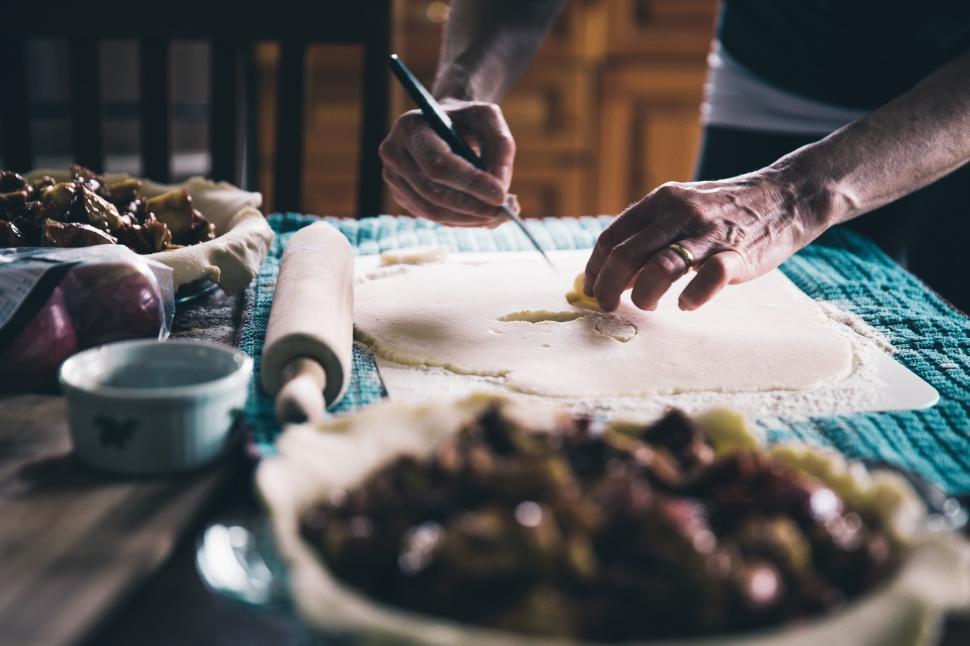 Free Image of A close-up of hands making pie in the kitchen 
