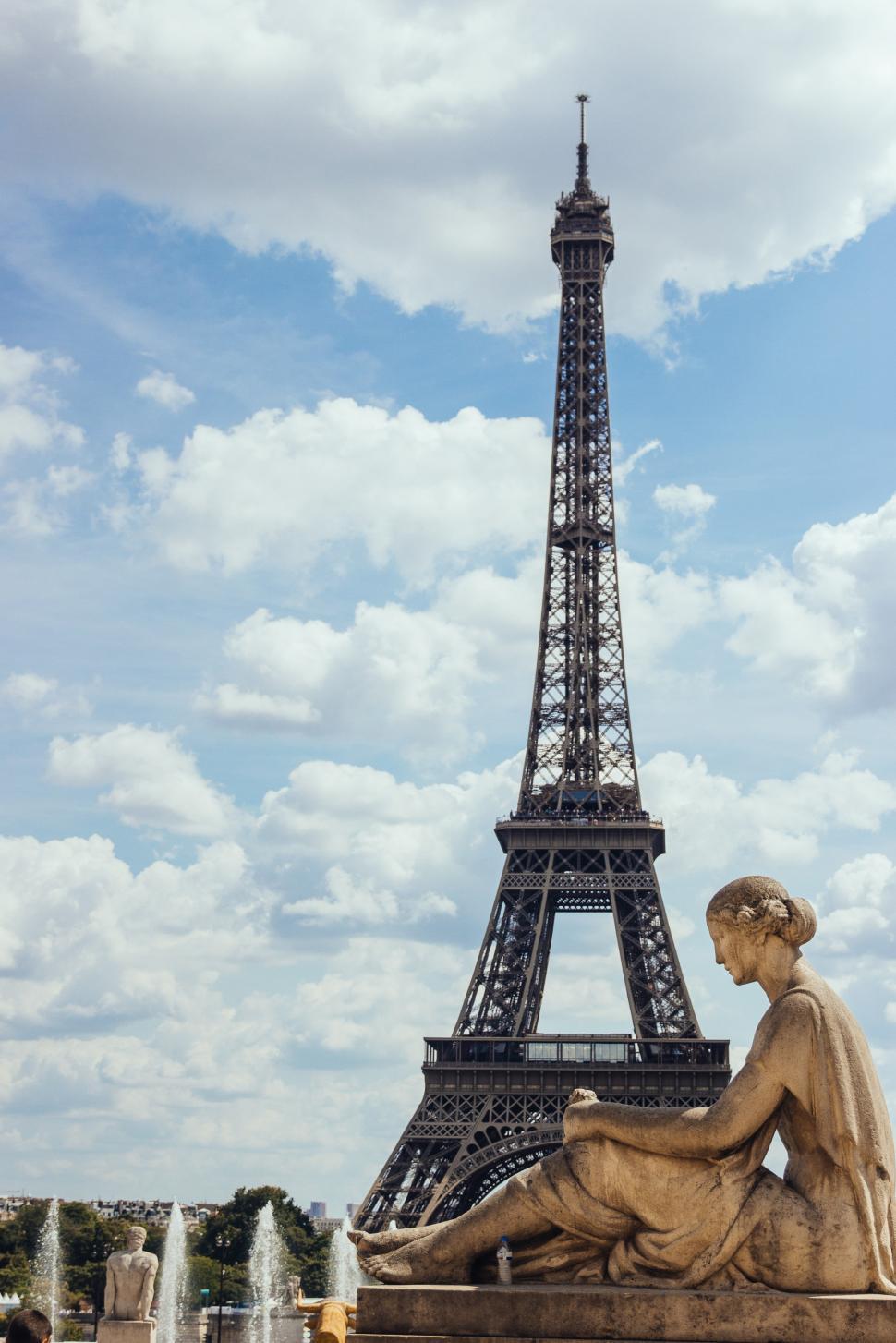 Free Image of A statue of woman with Eiffel Tower in the  background 