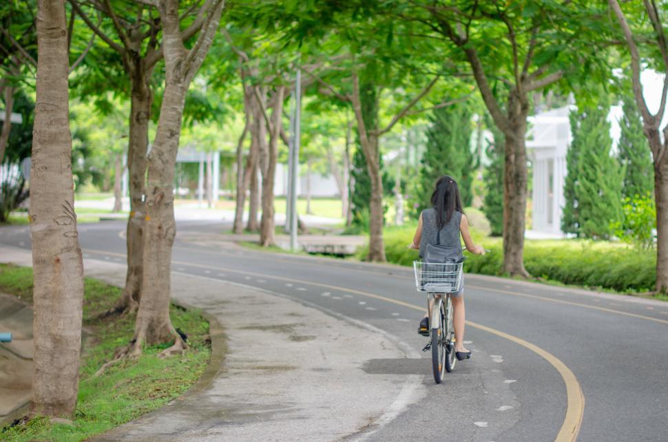 Free Image of Green Road with Cyclist Riding 