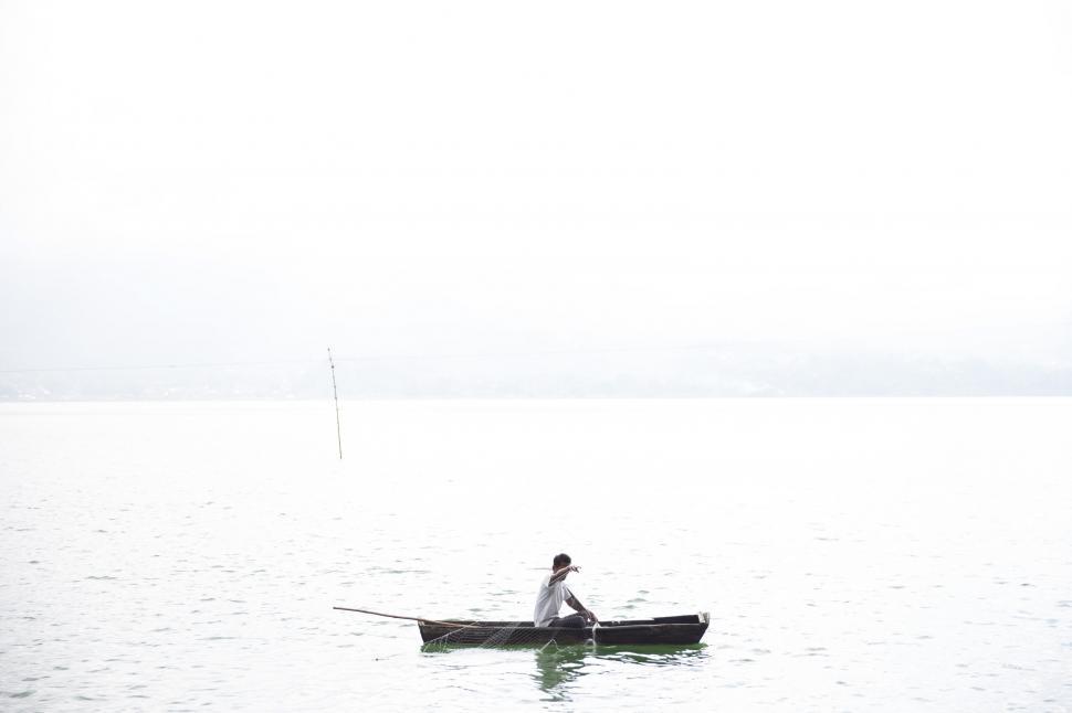 Free Image of A fisherman in a fishing boat 