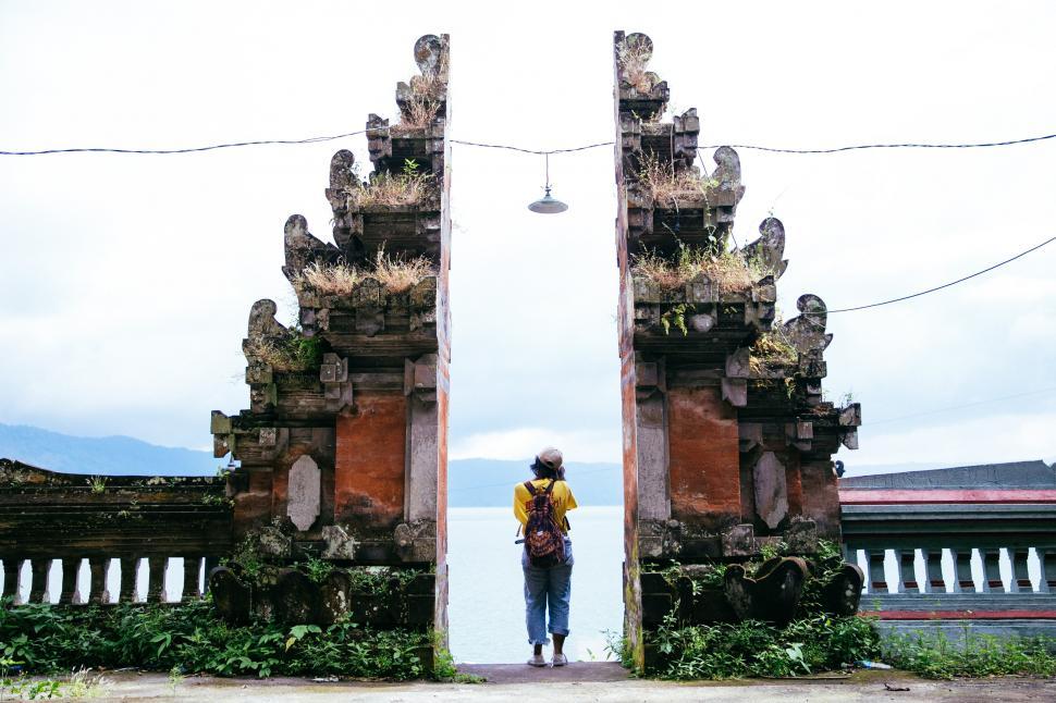 Free Image of A traveler standing at a temple s entrance 