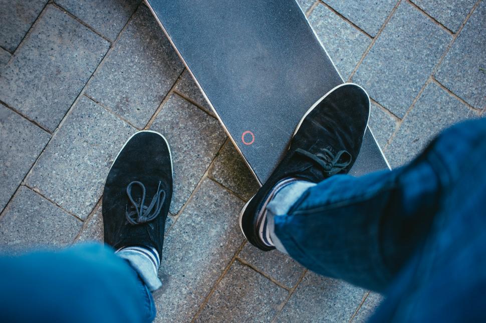 Free Image of A skater stepping on a skateboard deck 