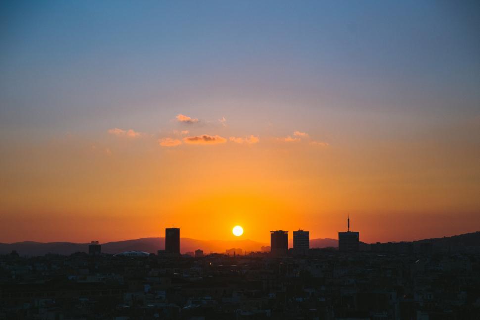 Download Free Stock Photo of Sun setting over a city 