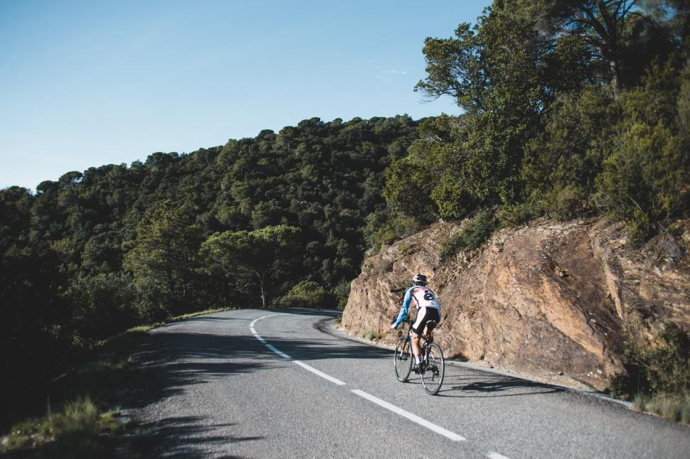 Free Image of Country road cyclist on a curvy road 